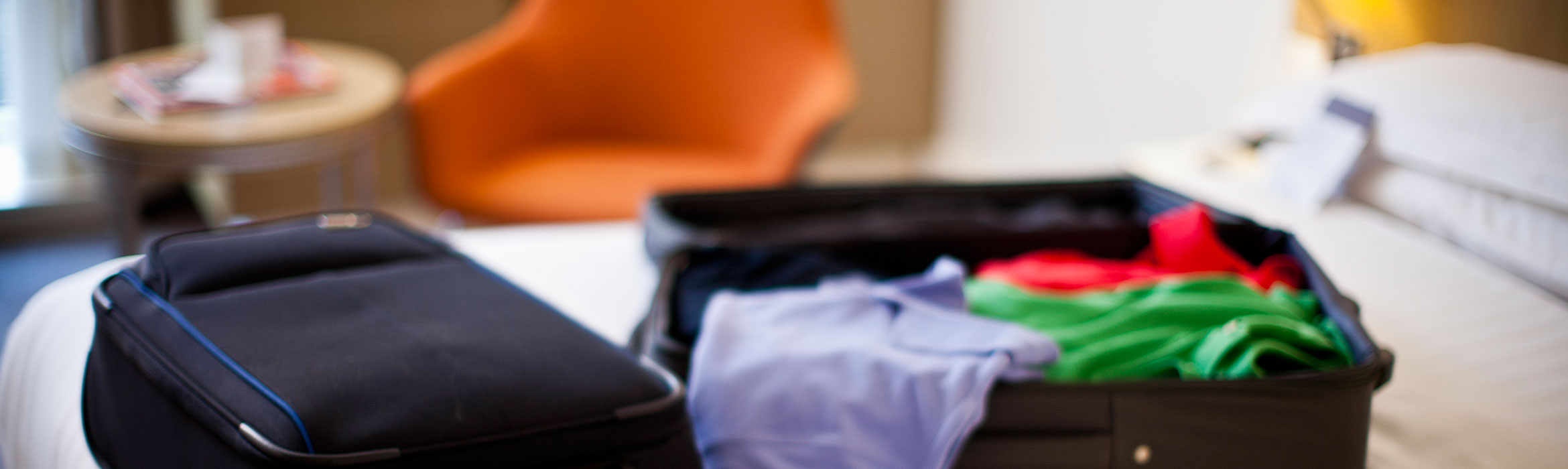 luggage half opened on a bed